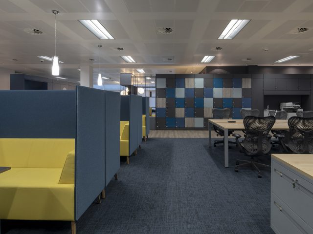 office scene with booths and chairs at desks